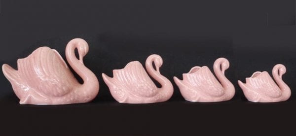 Set of four large, medium and small pink swans