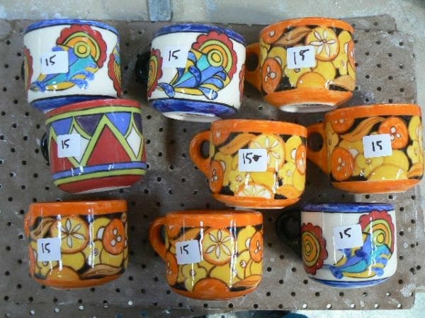 Bright mugs in orange and blues and reds